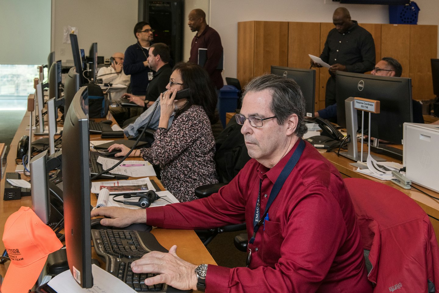 Diverse team working at computers in a busy office.